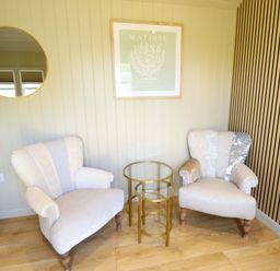A snug with two chairs and a table at Snowdrop in Grimsby