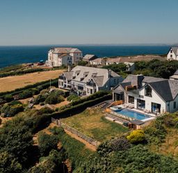 An outdoor area with houses and a swimming pool at Trevean in Mullion