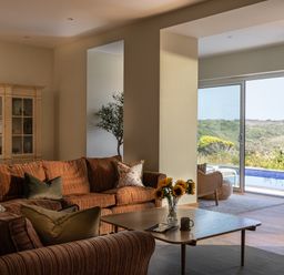 A living room with a sofa and coffee table at Trevean in Mullion