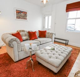 A living room with a sofa and coffee table at Fisherman’s Cottage