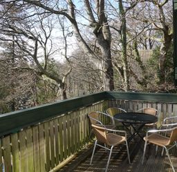 A balcony with table and chairs at Tor View Finlakes Holiday Park near Chudleigh