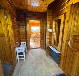 A hallway with wooden features and doors at Tor View near Finlakes Holiday Park near Chudleigh