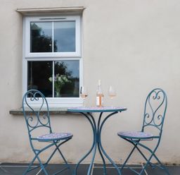 A table with two chairs and wine glasses at Glendale, Port Isaac