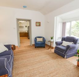 A living room with sofas and a table at Llain in Cardigan
