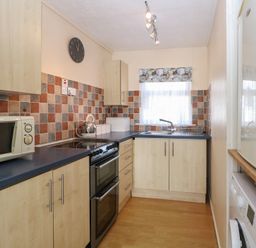 A kitchen with a sink and appliances at 440 California Sands