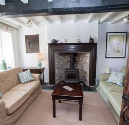 A living room with two sofas and a wood stove fireplace at The Cragg in Hawkshead