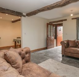 A living room with sofas and a table at Howgill Head in Kendal
