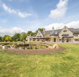Exterior view of a mansion with a pond and garden at Harcombe House Rooms Accessible Ground Floor Twin Chudleigh