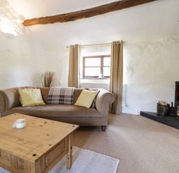 A living room with a sofa and fireplace at Cyffdy Cottage - Arenig in Bala