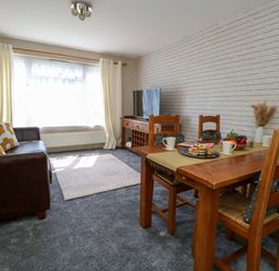 A living room with a dining area and a television at Lily's Pad Weston, Portland
