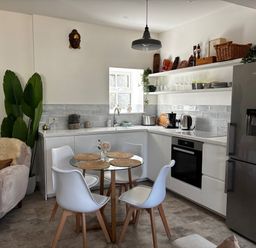 A kitchen with a dining table and chairs at Bracken Cottage in Osmington