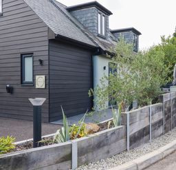 A house with a fence and plants at Tiddlywink near Indian Queens