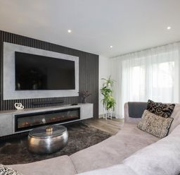 A living room with a television and sofa at Tiddlywink near Indian Queens