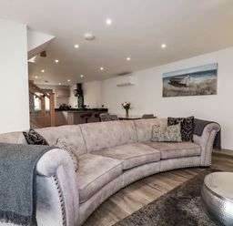 A living room with a sofa and table at Tiddlywink near Indian Queens