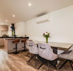 A kitchen with a dining table and chairs at Tiddlywink near Indian Queens