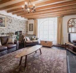 A living room with a coffee table and sofa at Coach House in Llangrannog