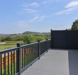 A deck area with a railing and fence at Castle View in Scarborough