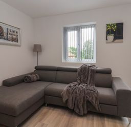 A living room with a sofa and window at Woodside in Scarborough