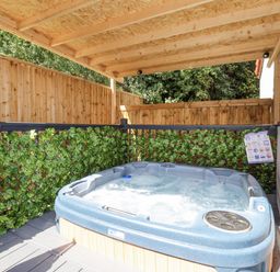 An outdoor hot tub surrounded by wooden fencing at Woodside in Scarborough