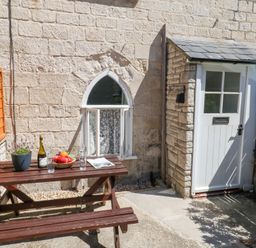 An outdoor area with a table and chairs at Driftwood in Weymouth