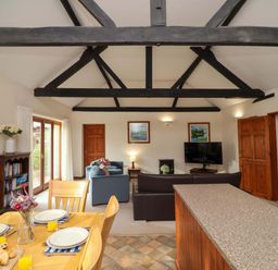 A living room with a dining area and furnishings at Beechwood in Wood Norton