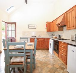 A kitchen with wooden cabinets and appliances at Willow in Wood Norton near Foulsham