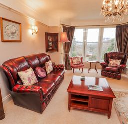 A living room with various seating and a coffee table at High Cross in Keswick