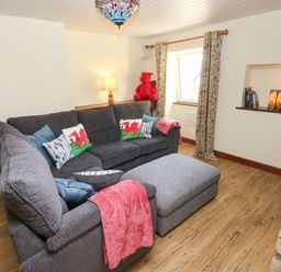 A living room with a sofa and window at Dolcoed near Llangadog