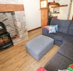 A living room with a fireplace and sofa at Dolcoed Manordeilo near Llangadog