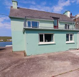 A house with a balcony and windows at O'Conells in Portmagee