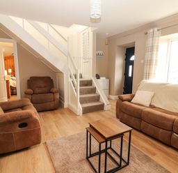 A living room with a sofa and recliner chairs at O'Connell's Lodge, Portmagee, County Kerry