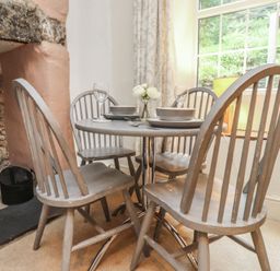 A dining room with a table and chairs at Tryfan Cottage in Nant Gwynant