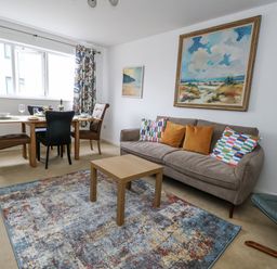 A living room with a table and chairs at Flat 13, Chesil House in Bridport