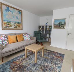A living room with a sofa and coffee table at Flat 13, Chesil House in Bridport