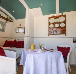 A seating area with a table and chairs at Songbirds in St Michaels, Kent