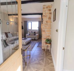 A living room with a sofa and chair at Yew Tree Cottage Mealsgate near Ireby