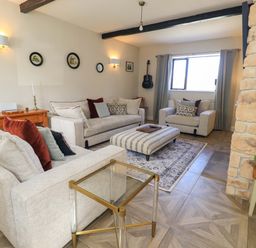 A living room with sofas and a coffee table at Yew Tree Cottage Mealsgate near Ireby