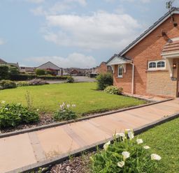 A house with a garden and pathway at 3 Hawk Place in Moresby Parks near Whitehaven