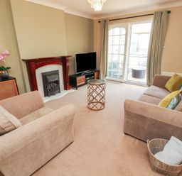 A living room with a sofa and television at 3 Hawk Place in Moresby Parks near Whitehaven