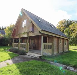 A wooden house with a porch and windows at Pen Y Clawdd near Beggar's Bush, Presteigne
