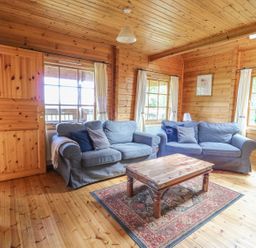 A living room with two sofas and a coffee table at Pen Y Clawdd near Beggar's Bush