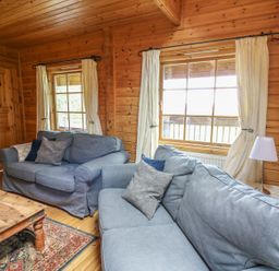 A living room with two sofas and a wooden table at Pen Y Clawdd near Beggar's Bush, Presteigne
