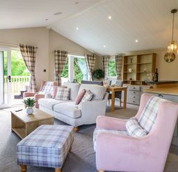 A living room with a sofa and dining area at The Owlet in Dolwen near Llanidloes