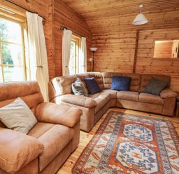 A living room with a sofa and armchair at Dan Y Coed near Beggar's Bush near Presteigne