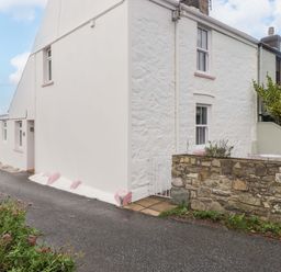 An exterior view of a house with a garden at Penwyn Solva