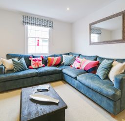 A living room with a couch and coffee table at Church Hill House Port Isaac