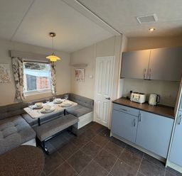 A kitchen with a dining area and appliances at Caravan 941 Clacton-On-Sea