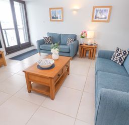 A living room with sofas and a coffee table at Tobys Quay in Falmouth