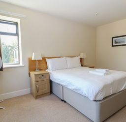 A bedroom with a bed and fan at Bedroom 10 in Littlehampton
