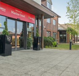 An outdoor area with an entrance to Marine Court at Littlehampton